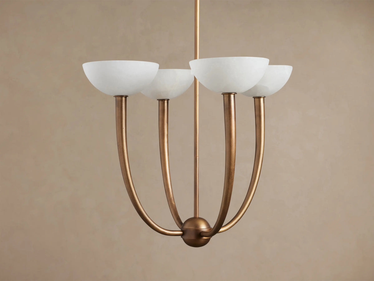Saguaro Chandelier: antique brass frame with four upward-curving arms, each holding a mottled white alabaster shade.