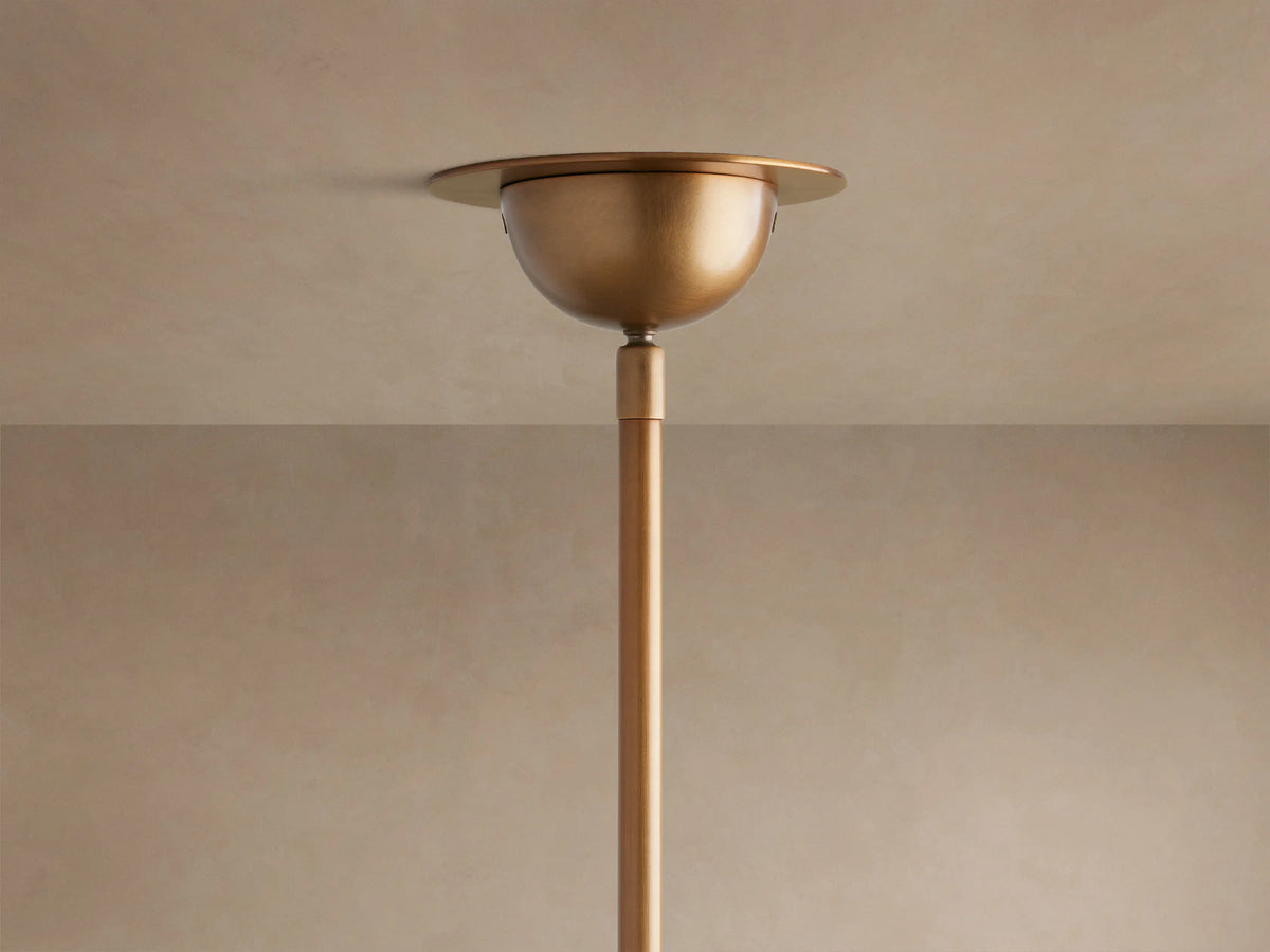 Detail of Saguaro Chandelier with multiple luminous white alabaster bowl shades on curved antique brass iron stems.
