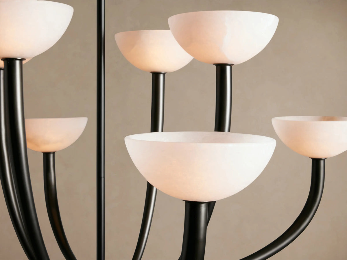 Saguaro Chandelier with 8 upward-curving dark metal arms and white, bowl-shaped alabaster shades.