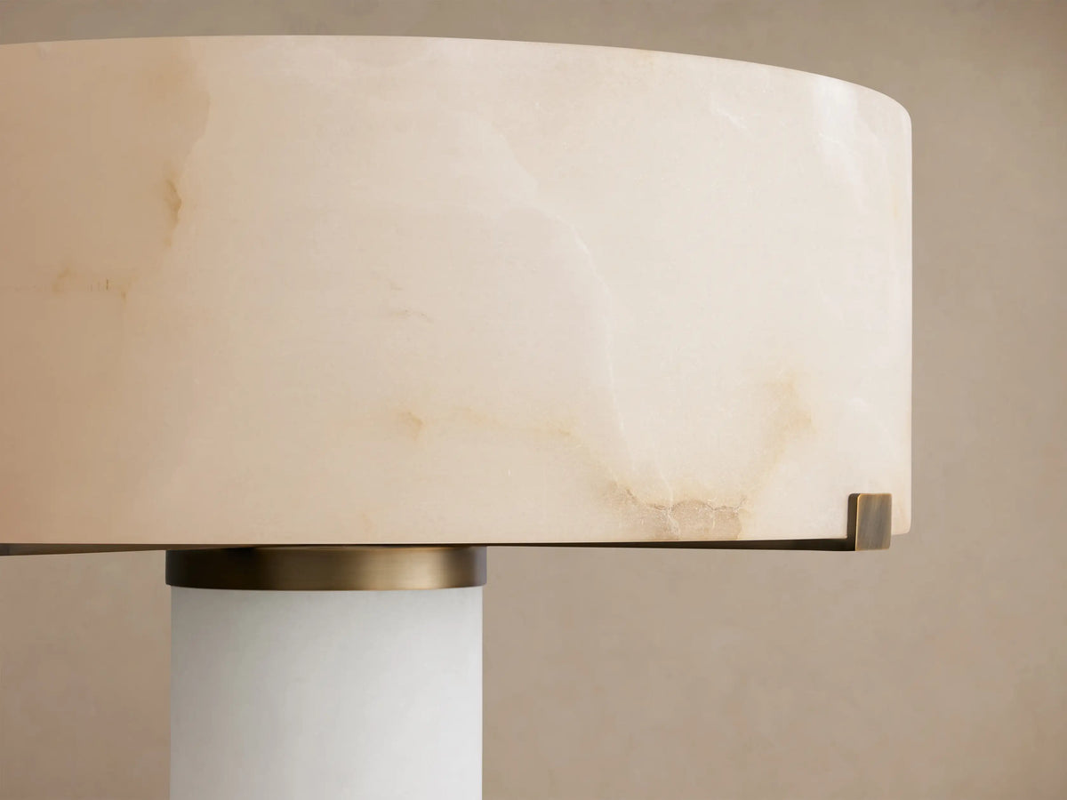 Cylindrical off-white alabaster shade of the Chayla Floor Lamp, with natural brown patterns and antique brass accents.