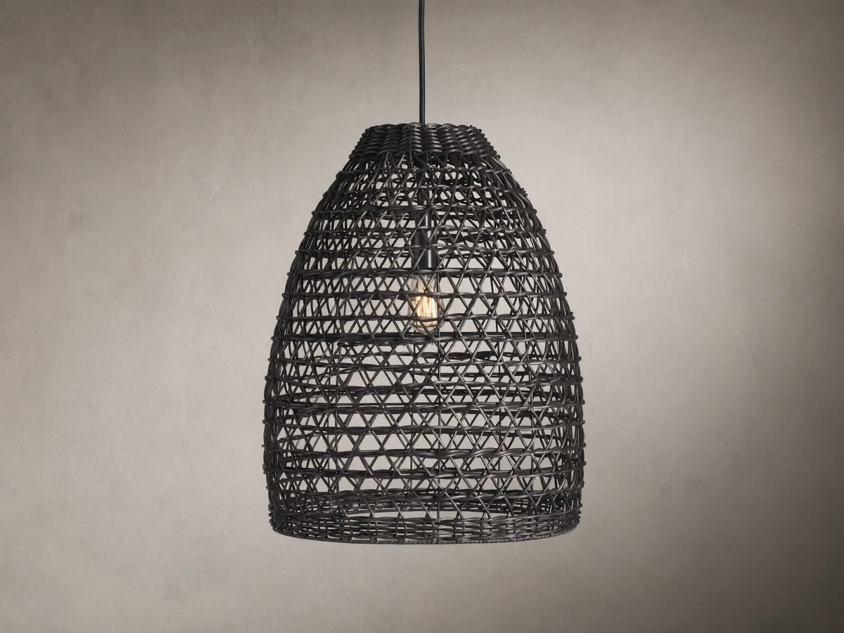 Braemar Outdoor Black Pendant with a woven all-weather wicker shade, hanging from a black fabric-wrapped cord, bulb visible within.