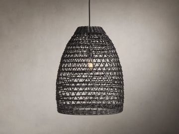 Braemar Outdoor Black Pendant with a woven all-weather wicker shade, hanging from a black fabric-wrapped cord, bulb visible within.