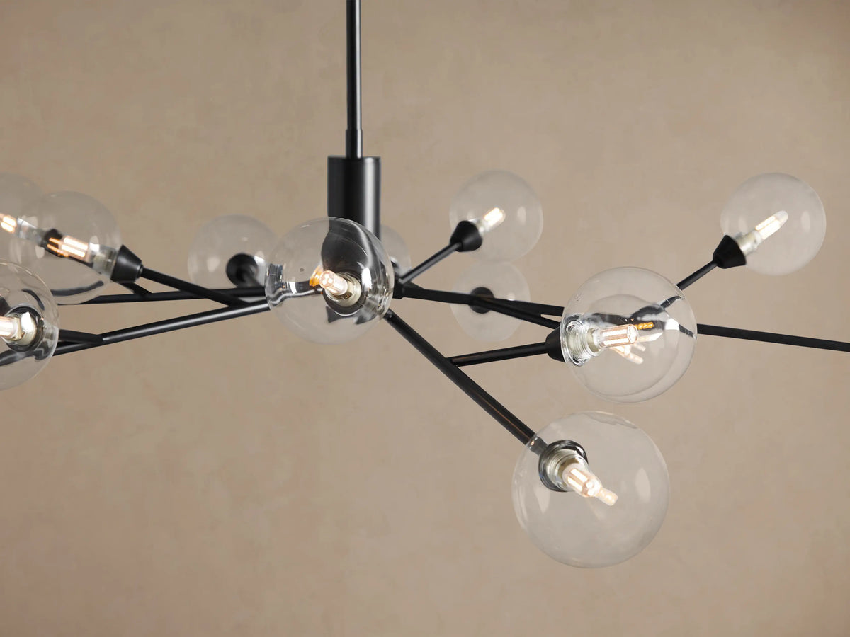 Apollo Round Chandelier featuring a black metal frame with multiple clear glass globe bulbs, suspended against a beige background.