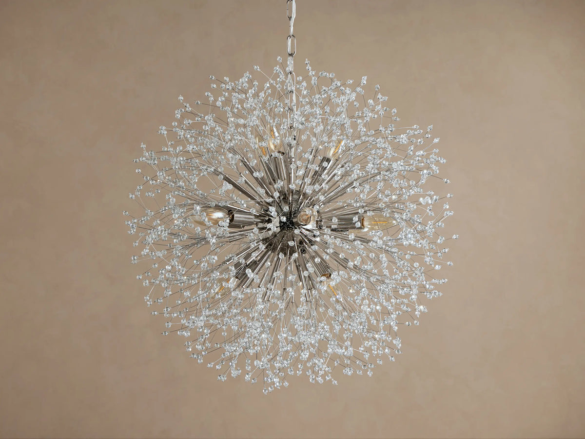 Dandelion Round Chandelier, nickel-plated with many thin arms radiating out, adorned with clear glass crystals and warm lit bulbs.