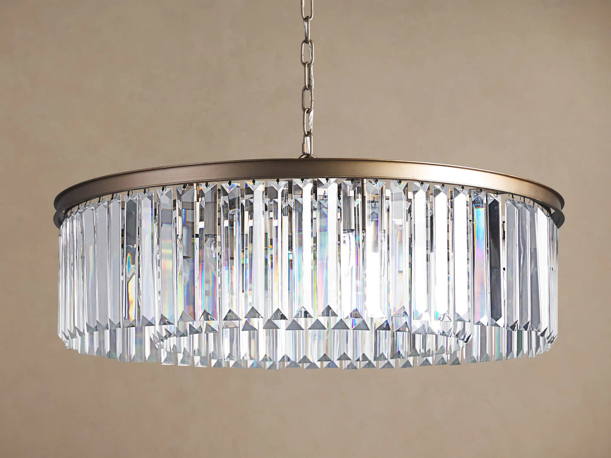 Leyland Round Chandelier with sparkling K9 crystals refracting light, dark bronze frame, suspended by a chain.