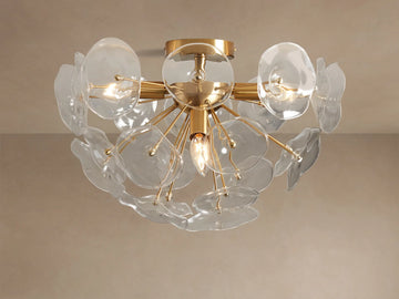 Gold Lily Flush Mount with multiple clear glass petals arranged around glowing bulbs, mounted on a neutral ceiling.