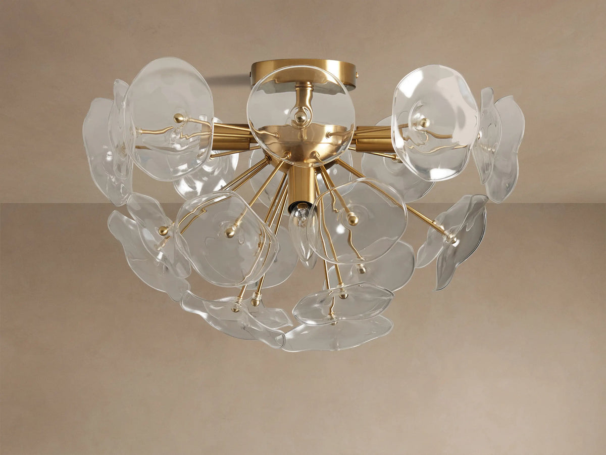 Gold Lily Flush Mount with multiple clear glass petals arranged around glowing bulbs, mounted on a neutral ceiling.