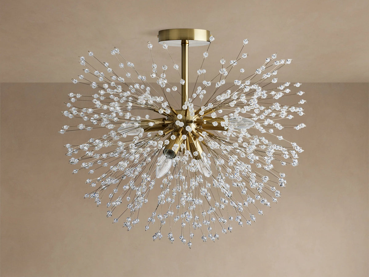 Gold Dandelion Flush Mount with sparkling clear crystal beads extending in a starburst, lights emitting warm glow on a neutral ceiling.