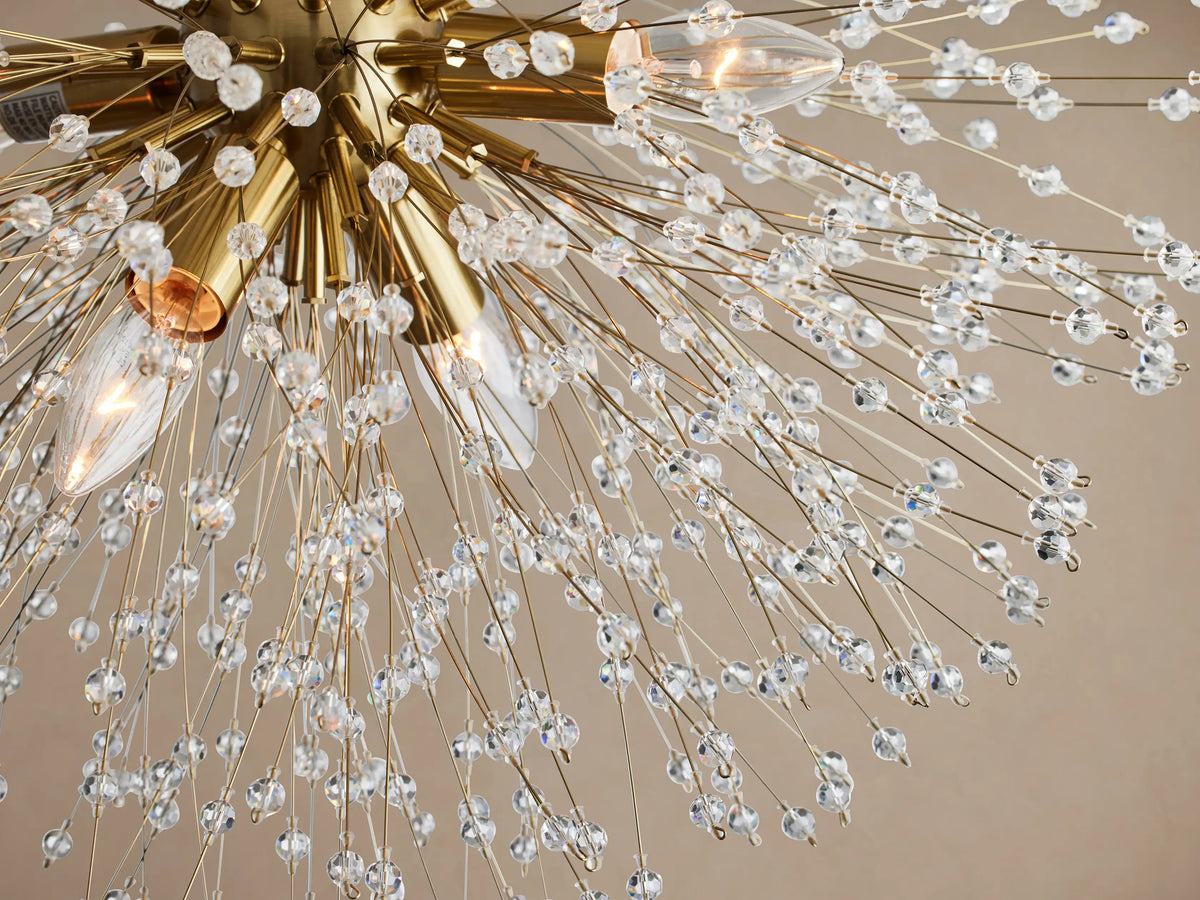 Dandelion Flush Mount, a spherical gold-plated light fixture with hundreds of crystal-tipped wires radiating outward.