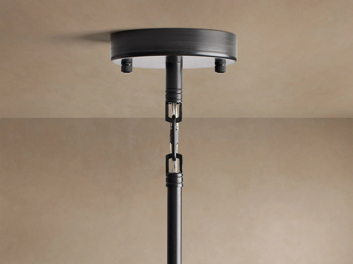 Modern Apollo Round Chandelier with black iron frame, multiple clear glass globes, glowing with warm LED bulbs.