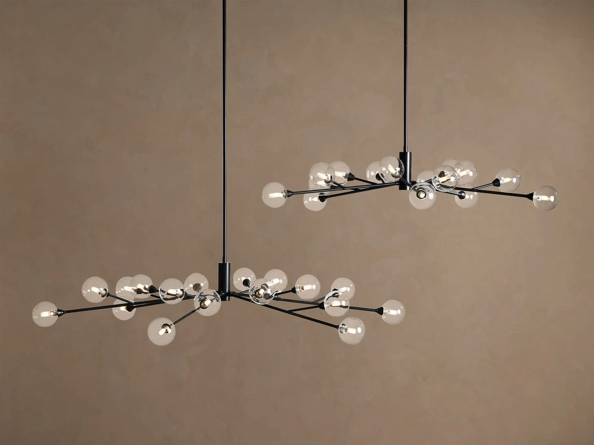 Apollo Round Chandelier's antiqued bronze canopy on a beige ceiling, with a dark rod connected by a chain link extending down.