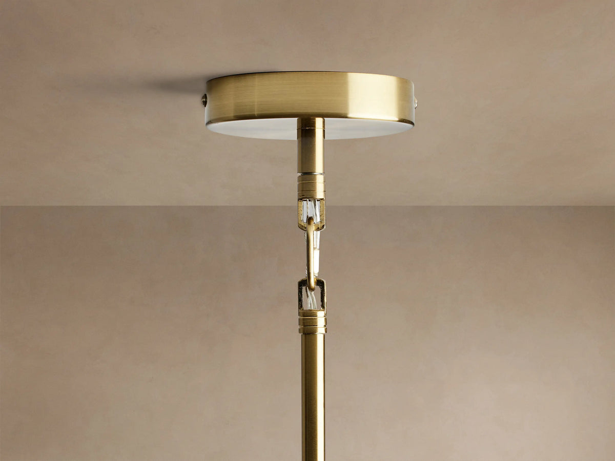 Close-up of Apollo Round Chandelier. Gold-plated brass rods extend with clear glass globes, each containing an illuminated bulb.