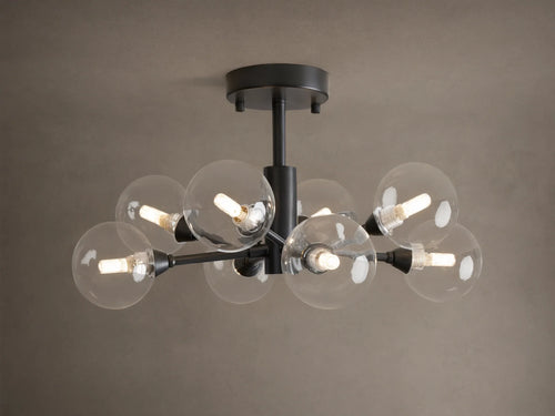 Apollo Flush Mount, dark metal, with eight clear spherical bulbs glowing. Mounted on a light brown ceiling.