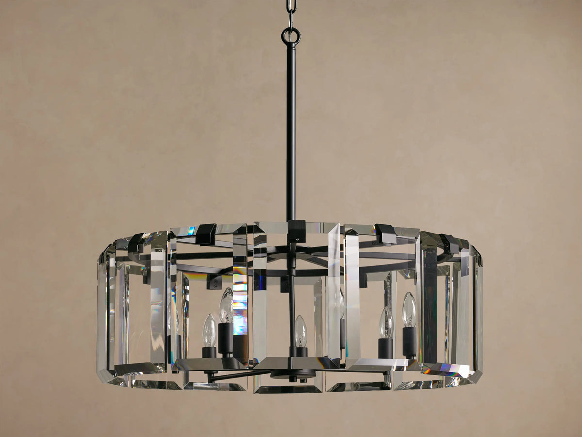 Amaya Round Chandelier: faceted clear crystals, dark frame, and 5 candelabra bulbs, suspended against a plain beige background.