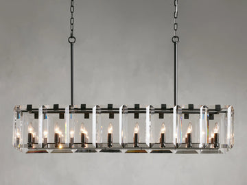 Rectangular chandelier with clear crystal panels and black iron frame, featuring twelve lit candle-style bulbs, hanging from chains.