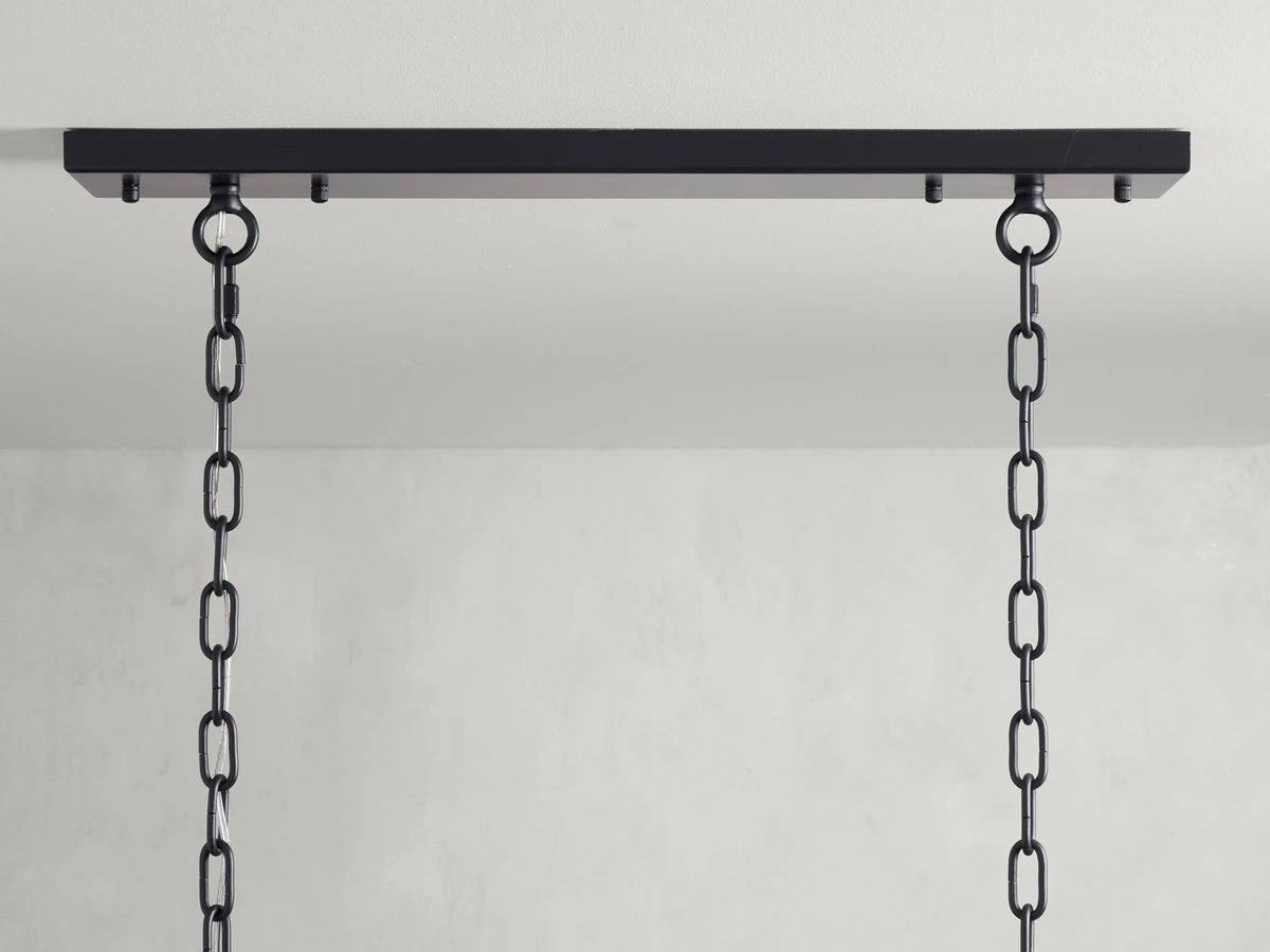 Amaya Rectangular Chandelier's black iron canopy with two attached black chains against a light gray background.