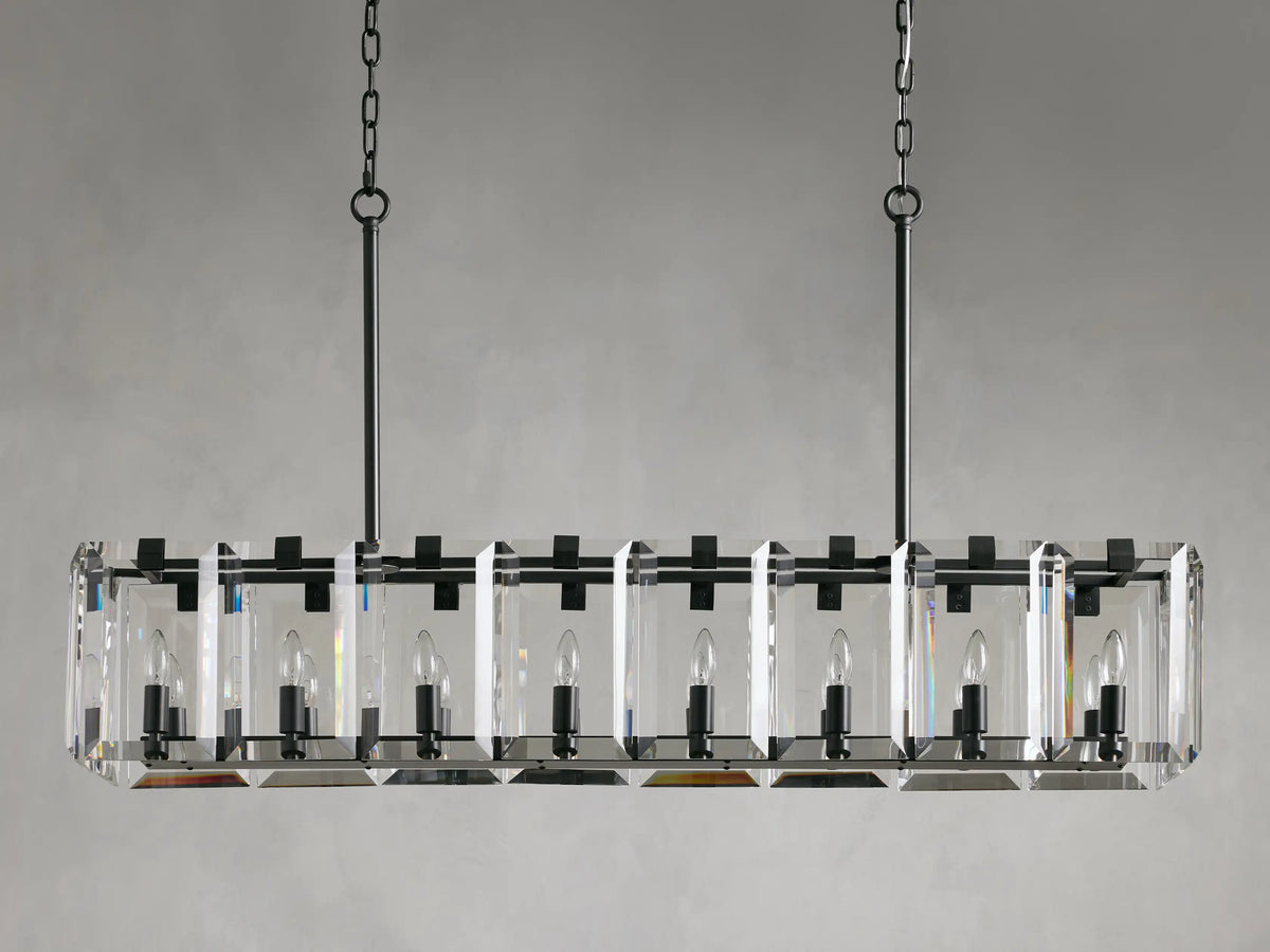 Rectangular chandelier with clear crystal prisms and black iron frame, suspended by two chains, featuring visible candle-style bulbs.