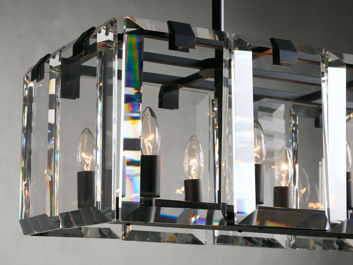 Clear crystal and iron Amaya Rectangular Chandelier with visible candle-style bulbs, reflecting light on thick rectangular crystal panels.