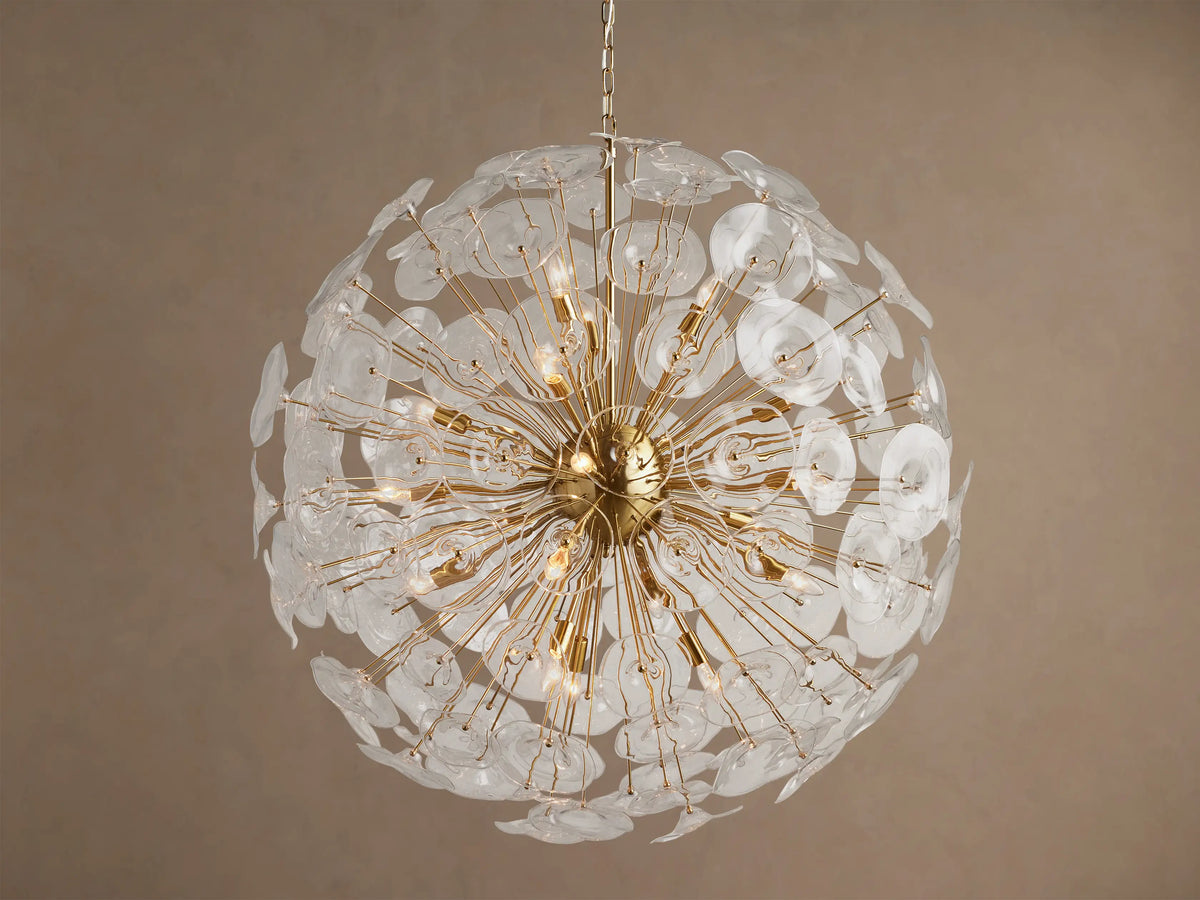 A large, round Lily Chandelier made of golden rods and many clear glass petals, with lights glowing inside.