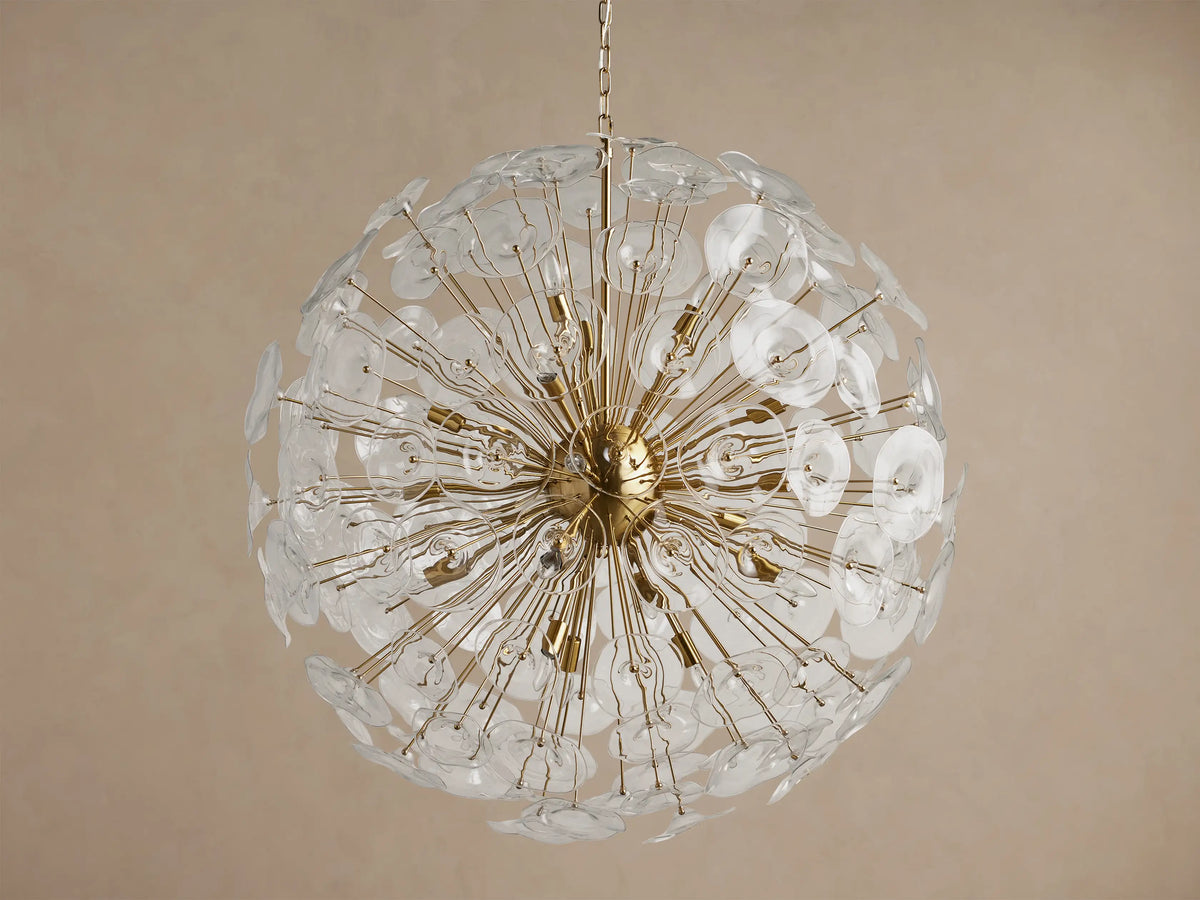 A large, round Lily Chandelier made of golden rods and many clear glass petals, with lights glowing inside.