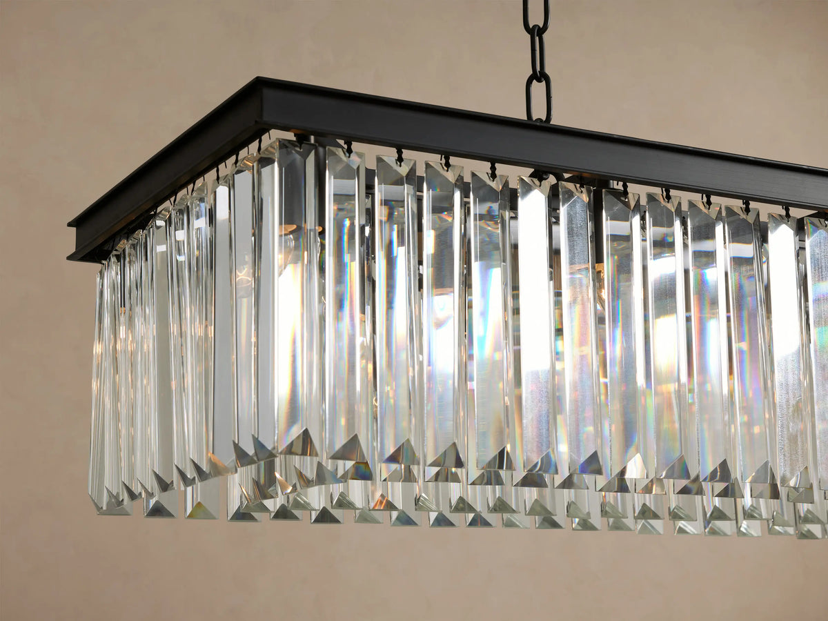 Leyland Rectangular Chandelier with rows of clear faceted K9 glass crystals hanging from a dark rectangular frame, suspended by chains.