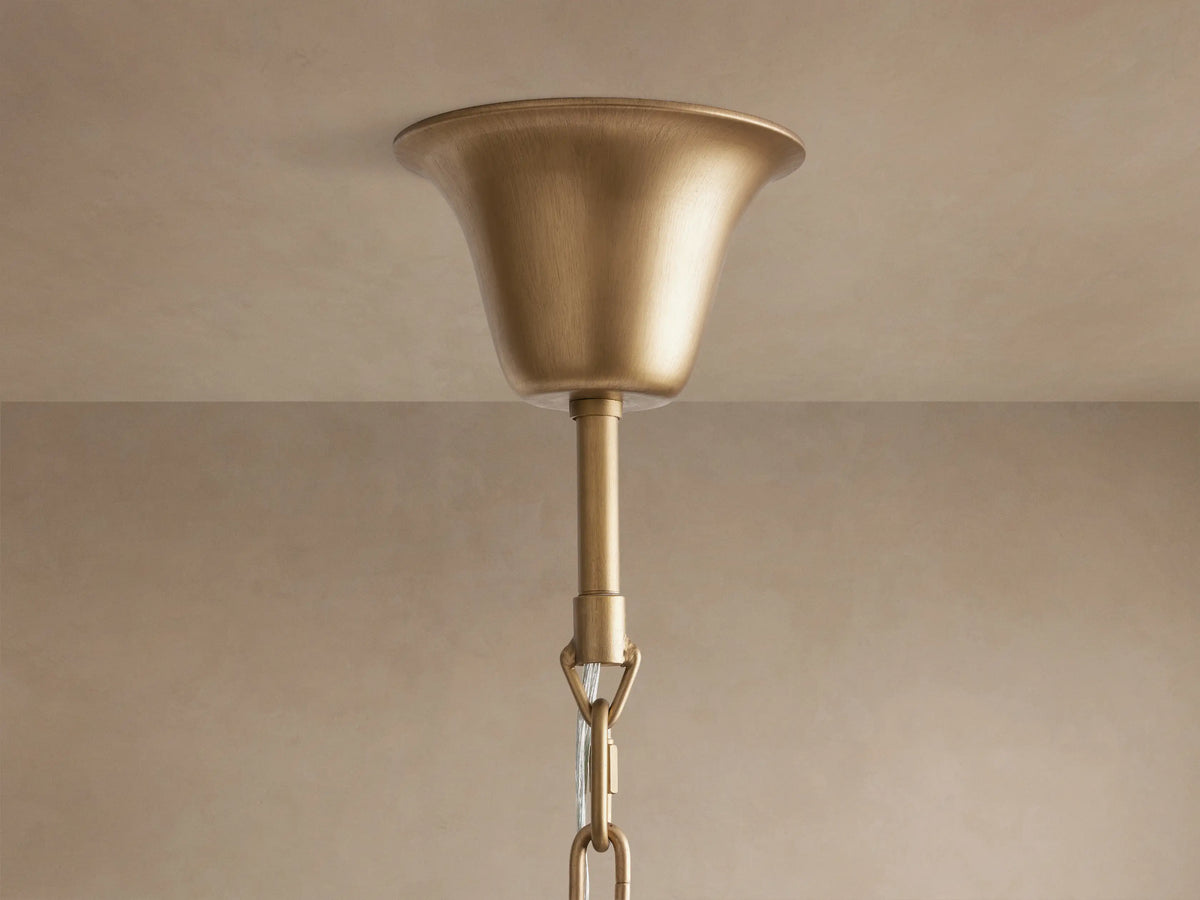 Leyland Tiered Round Chandelier close-up, showing multiple tiers of sparkling K9 glass crystals. Warm light illuminates the bronze-finished frame.