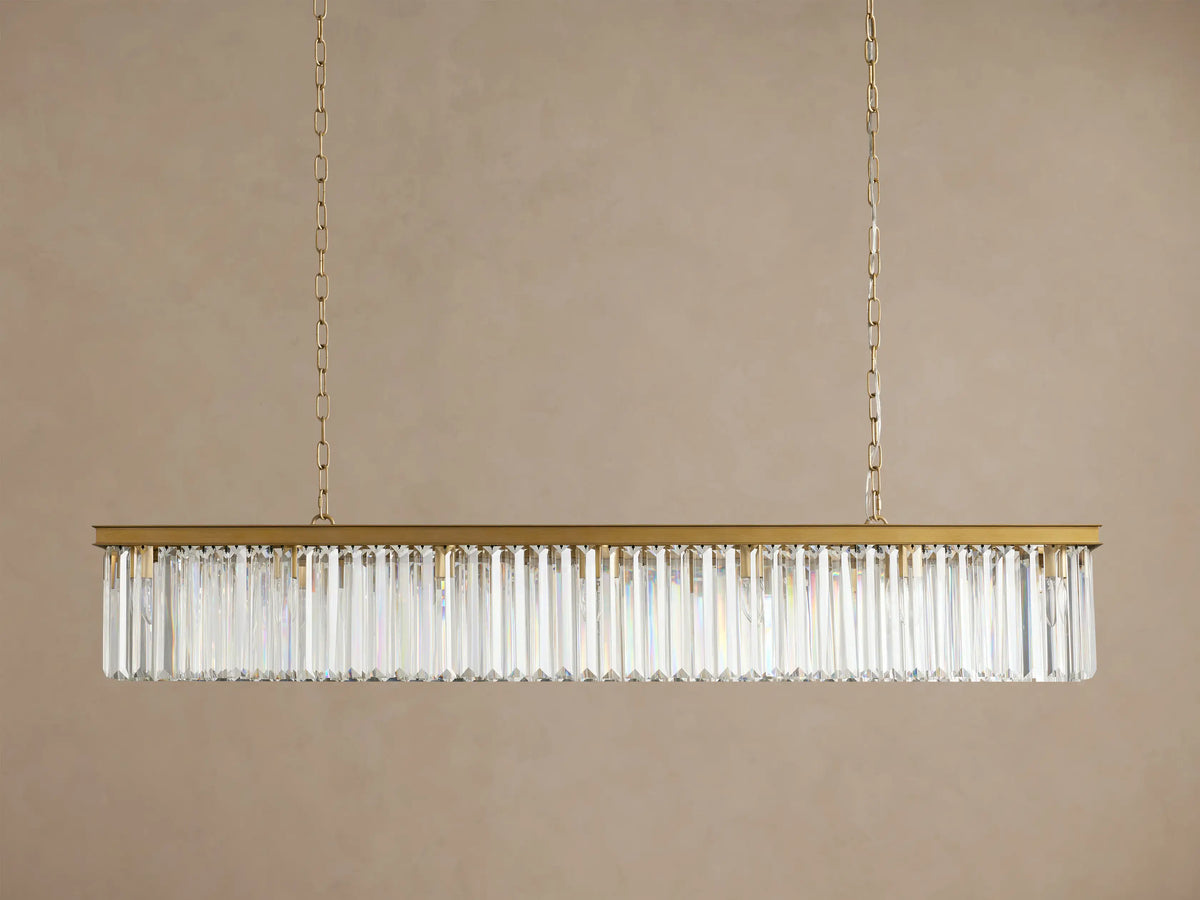 Leyland Rectangular Chandelier: Gold-toned frame with rows of clear, multifaceted K9 glass crystals, illuminated, hanging.