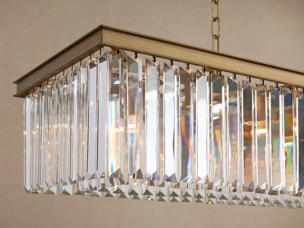 Leyland Rectangular Chandelier with a gold-toned frame, suspended by two chains, adorned with rows of clear faceted crystals.