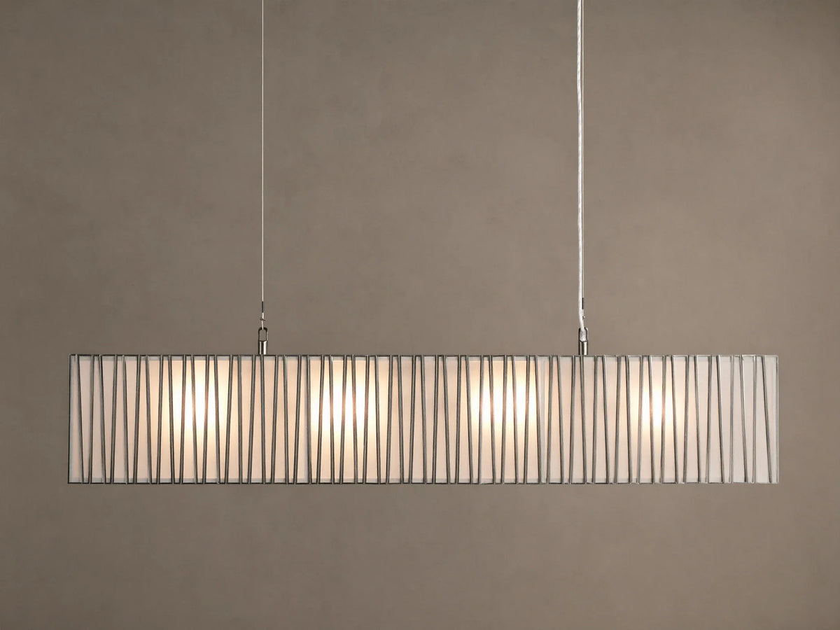 Horizontal Jeunet Rectangular Chandelier in Nickel, hanging against a tan wall, showing glowing white panels through vertical nickel bars.