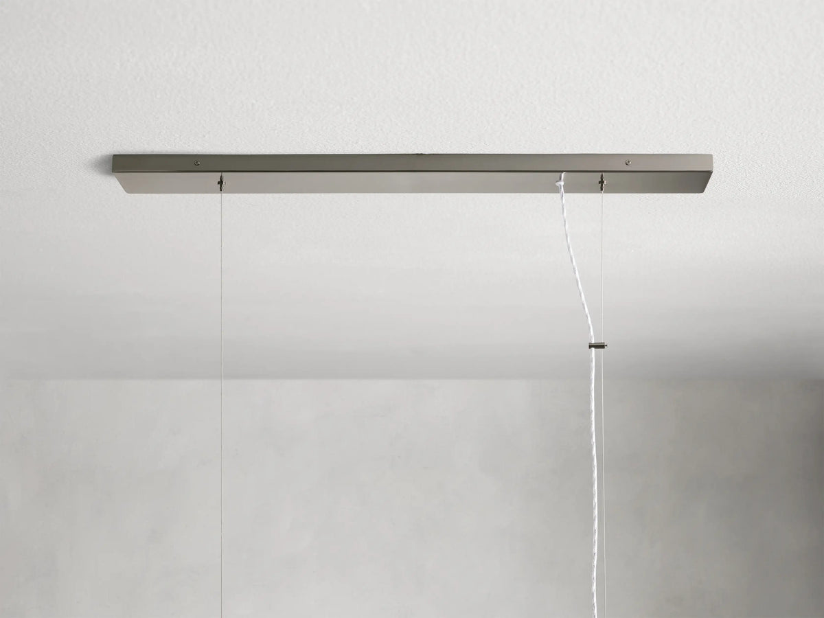 Jeunet Rectangular Chandelier in nickel, with vertical metal slats and frosted panels emitting a warm light.
