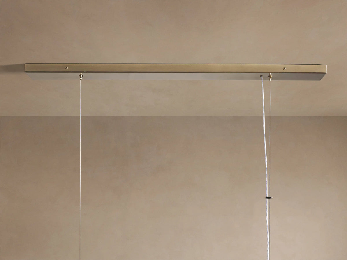 Jeunet Rectangular Chandelier with antiqued brass frame and glowing, textured glass panels, angled view.