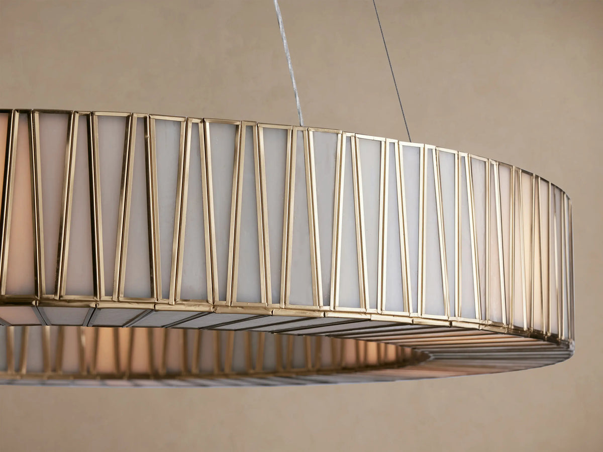 Jeunet Round Chandelier, antiqued brass iron frame with vertical geometric patterns, and frosted glass diffuser.