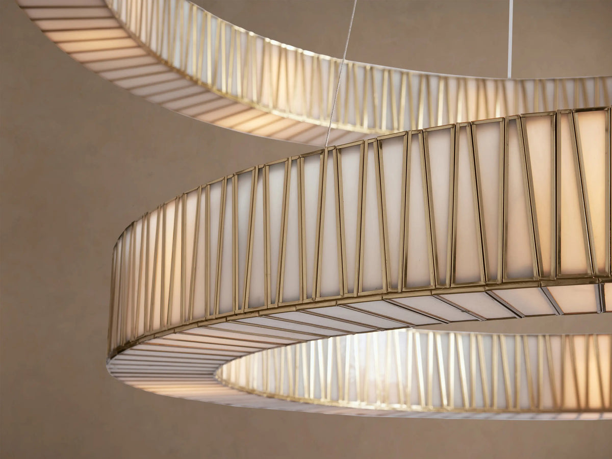 Jeunet 2-Tier Round Chandelier with antiqued brass finish and textured glass panels, hanging on a light brown background.