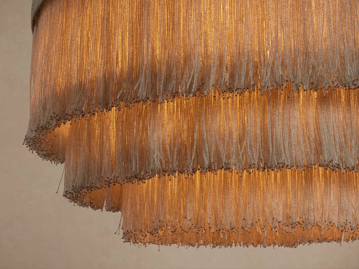 Romilly Tiered Chandelier, light grey, with four graduated tiers of delicate, shimmering glass bead fringe, hanging.