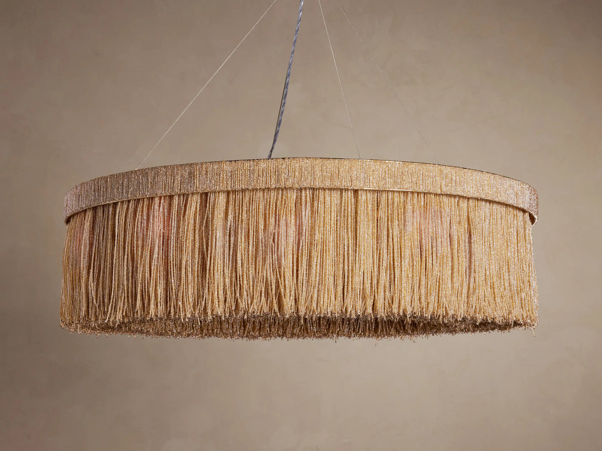 Romilly Round Chandelier: Round fixture with dense, vertical strands of golden glass beads, suspended from above.