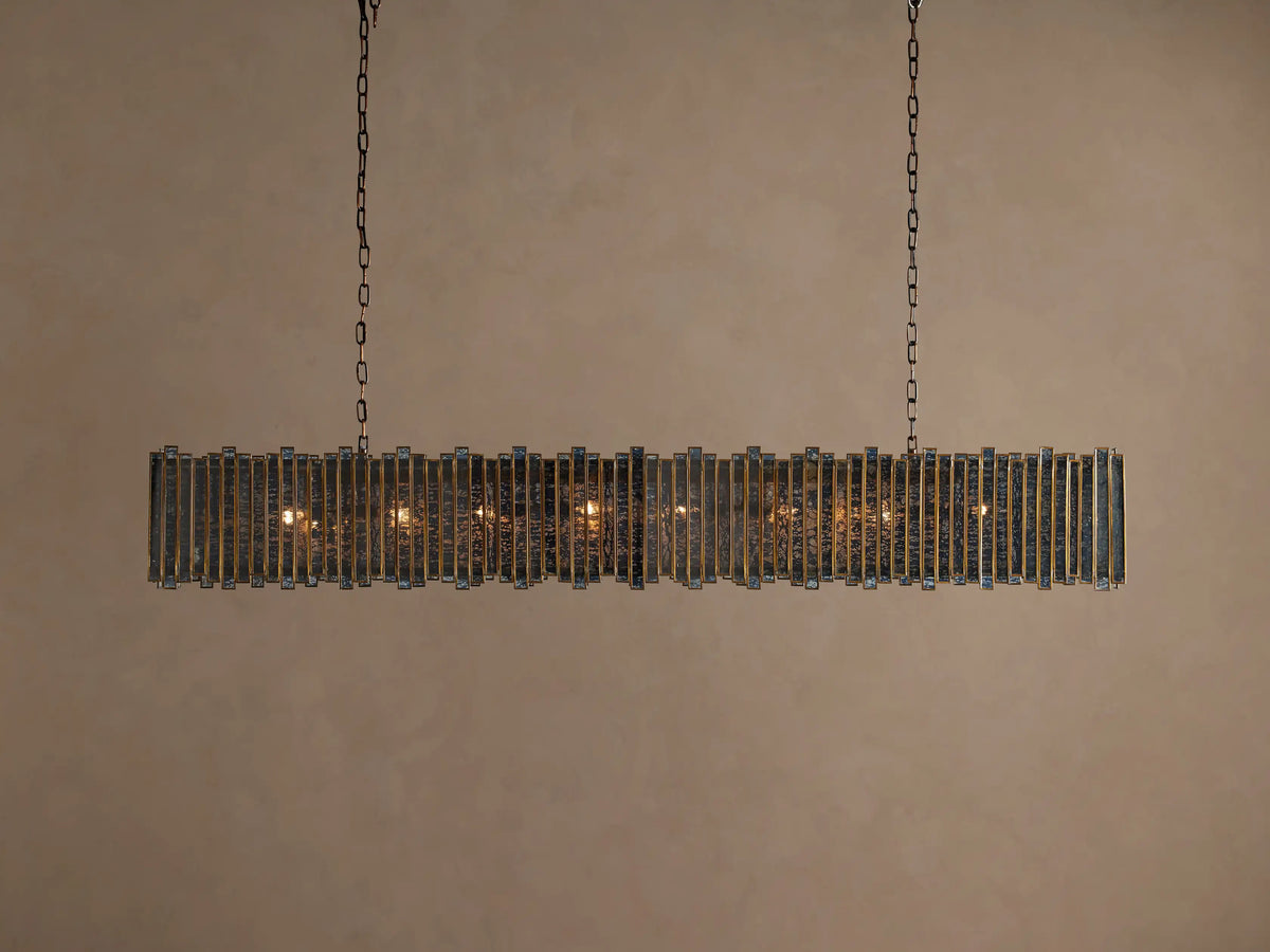 Laila Rectangular Chandelier, antique copper iron/brass frame with vertical antiqued mirrored-glass panes, glowing warm lights, hanging from chains.