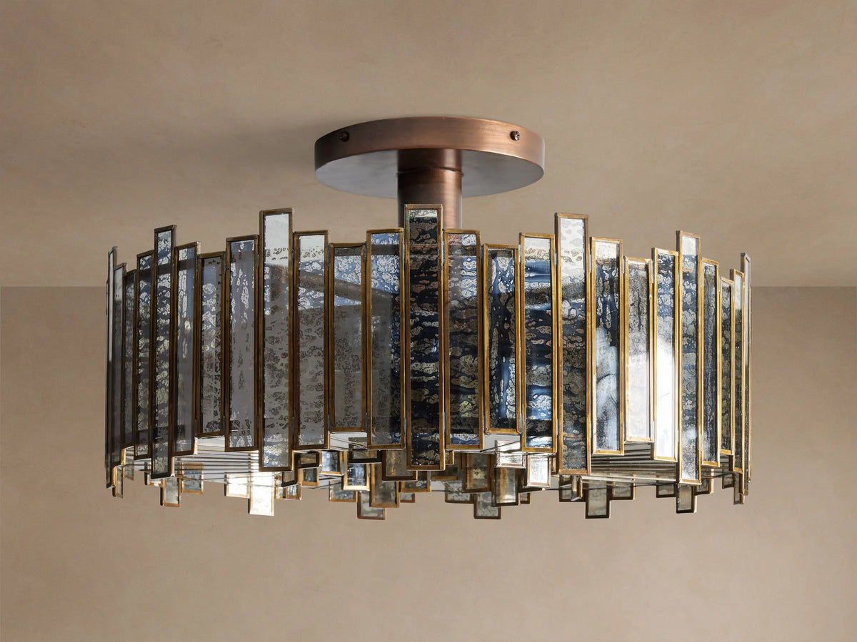 Laila Flush Mount with antique copper canopy, surrounded by rectangular antiqued mirrored-glass panes in a brass frame, lights glowing.