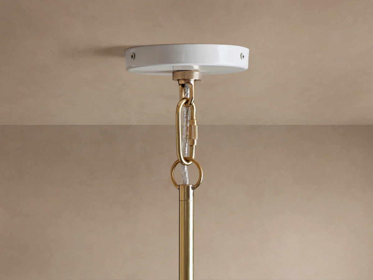 Close-up of Bonham Pendant showing white exterior shade & contrasting gold brass interior with two lit filament bulbs.