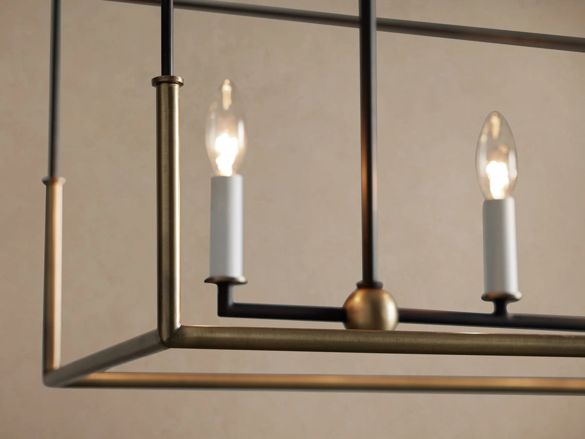 Holt Linear Chandelier: black rectangular frame, antiqued brass inner bar with 5 candle bulbs, suspended by dark chains.