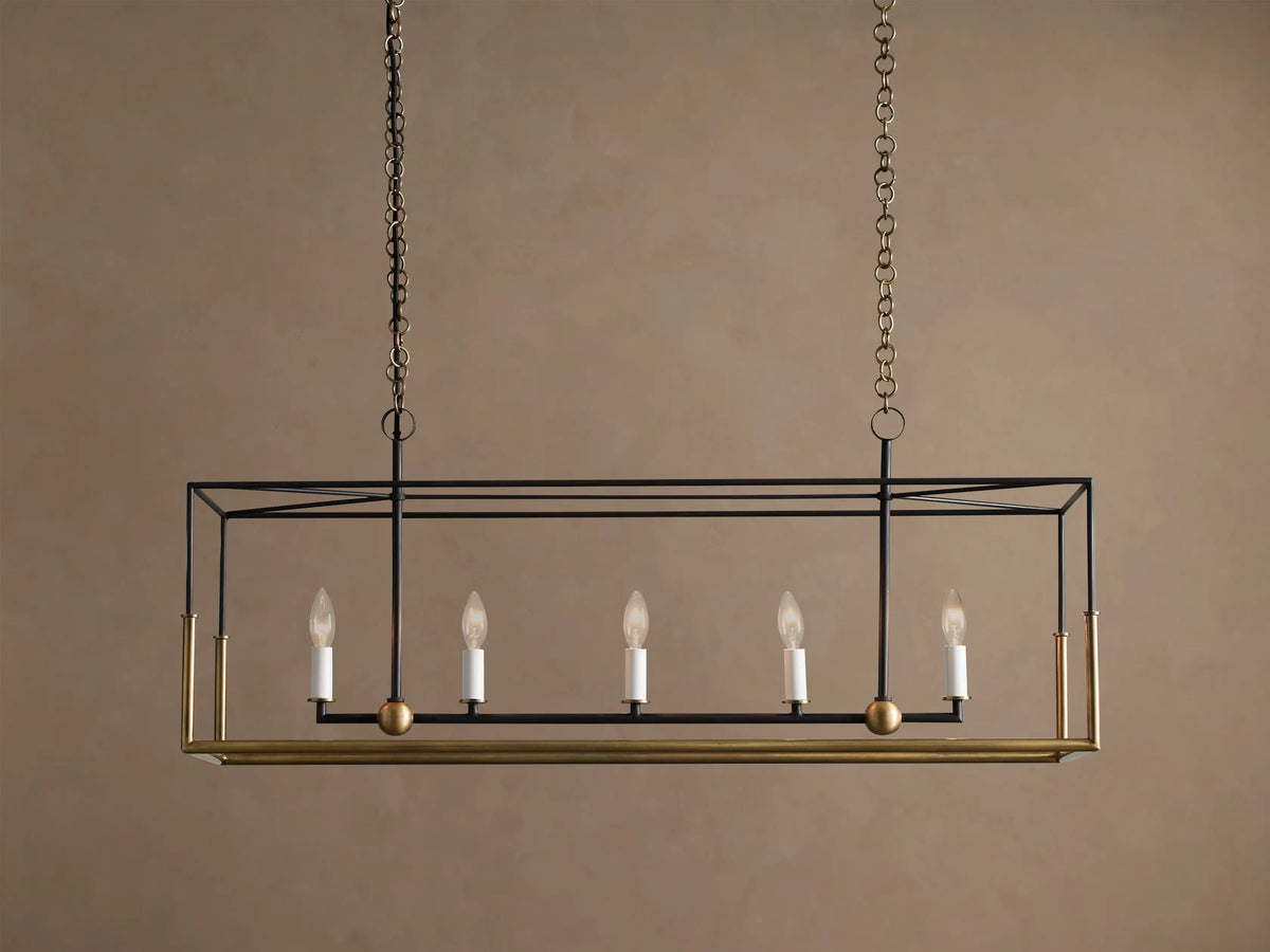 Holt Linear Chandelier: black rectangular frame with antiqued brass accents, 5 unlit candle bulbs, suspended by chains.
