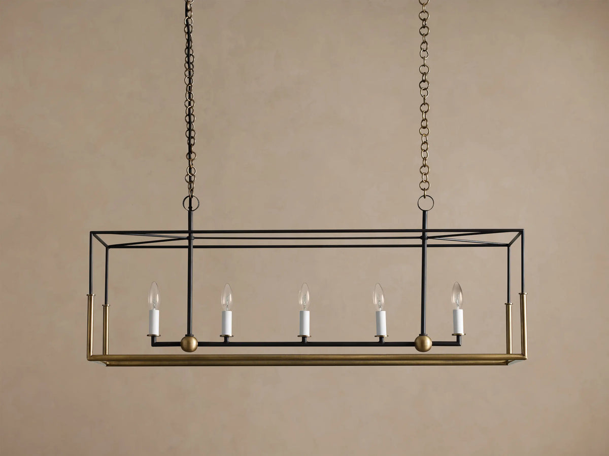 Holt Linear Chandelier: black rectangular frame with antiqued brass accents, 5 unlit candle bulbs, suspended by chains.