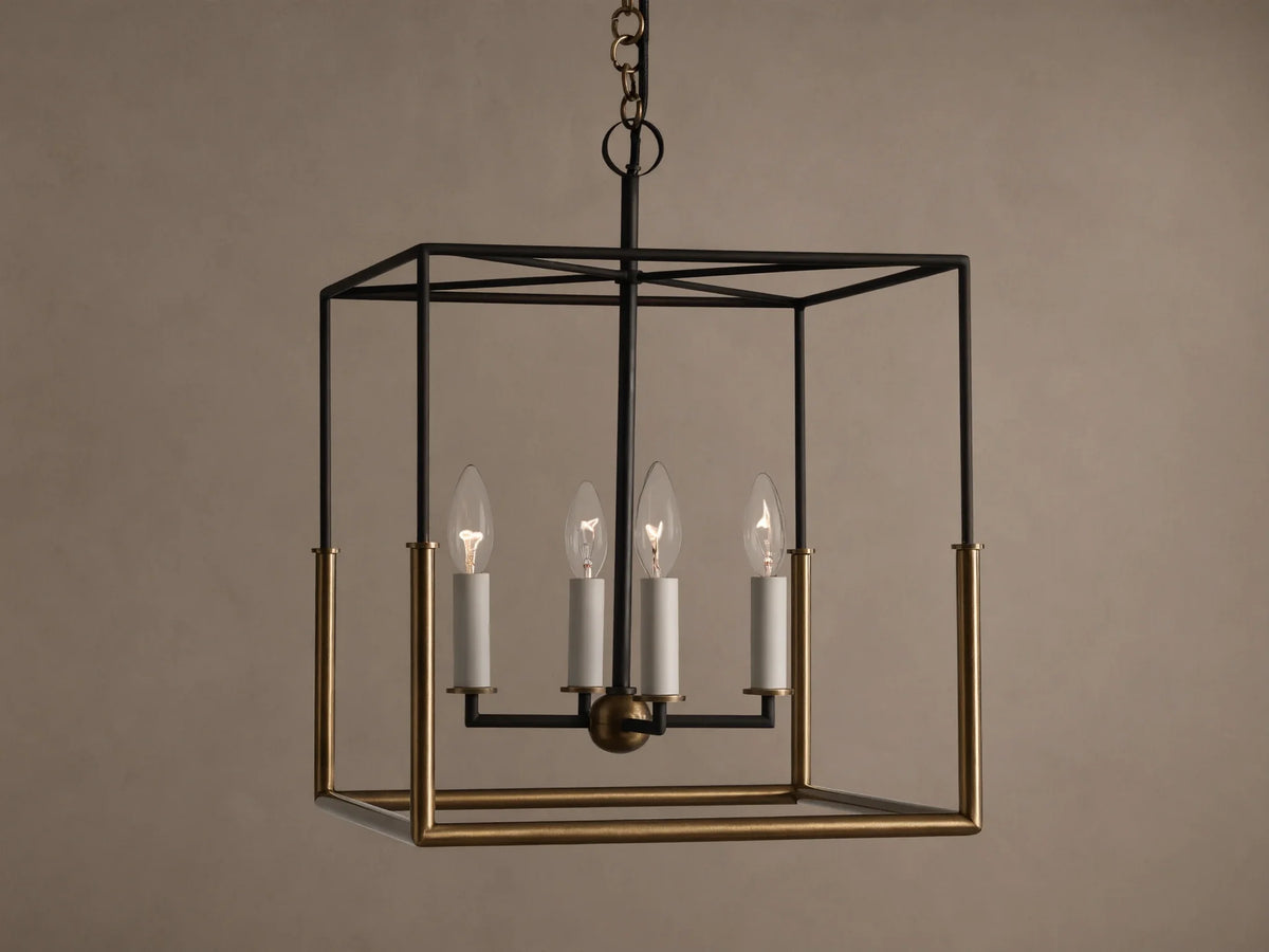 Holt Square Pendant, a square, open-cage light fixture with black and antiqued brass frames, featuring four clear candle-style bulbs.