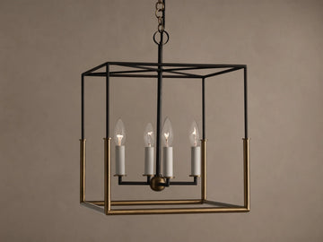 Holt Square Pendant, a square, open-cage light fixture with black and antiqued brass frames, featuring four clear candle-style bulbs.