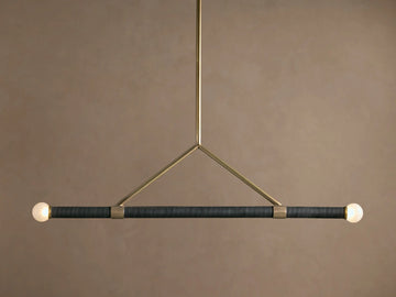 Randall Leather Pendant: Dark leather-wrapped horizontal bar with two frosted globe bulbs, suspended by a burnished brass frame.