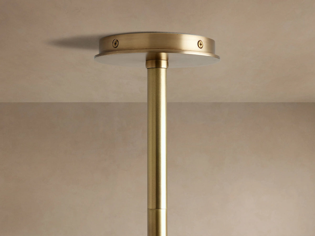 Close-up of Randall Leather Pendant's dark, ribbed leather-wrapped bar with burnished brass connection to an angled rod.