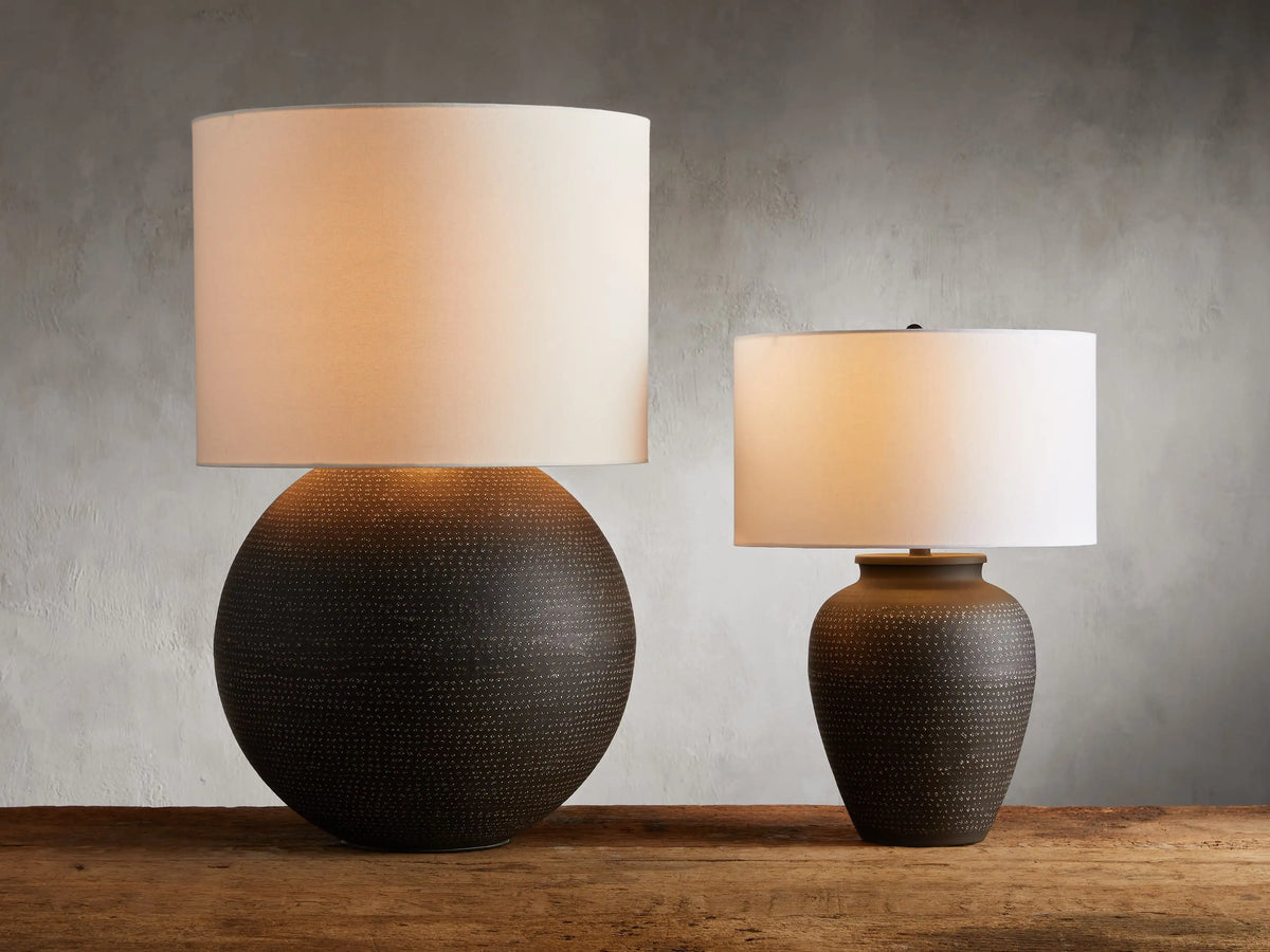 Howell Table Lamp with an embossed, powder-coated base in dark finish, paired with a white cotton linen shade.