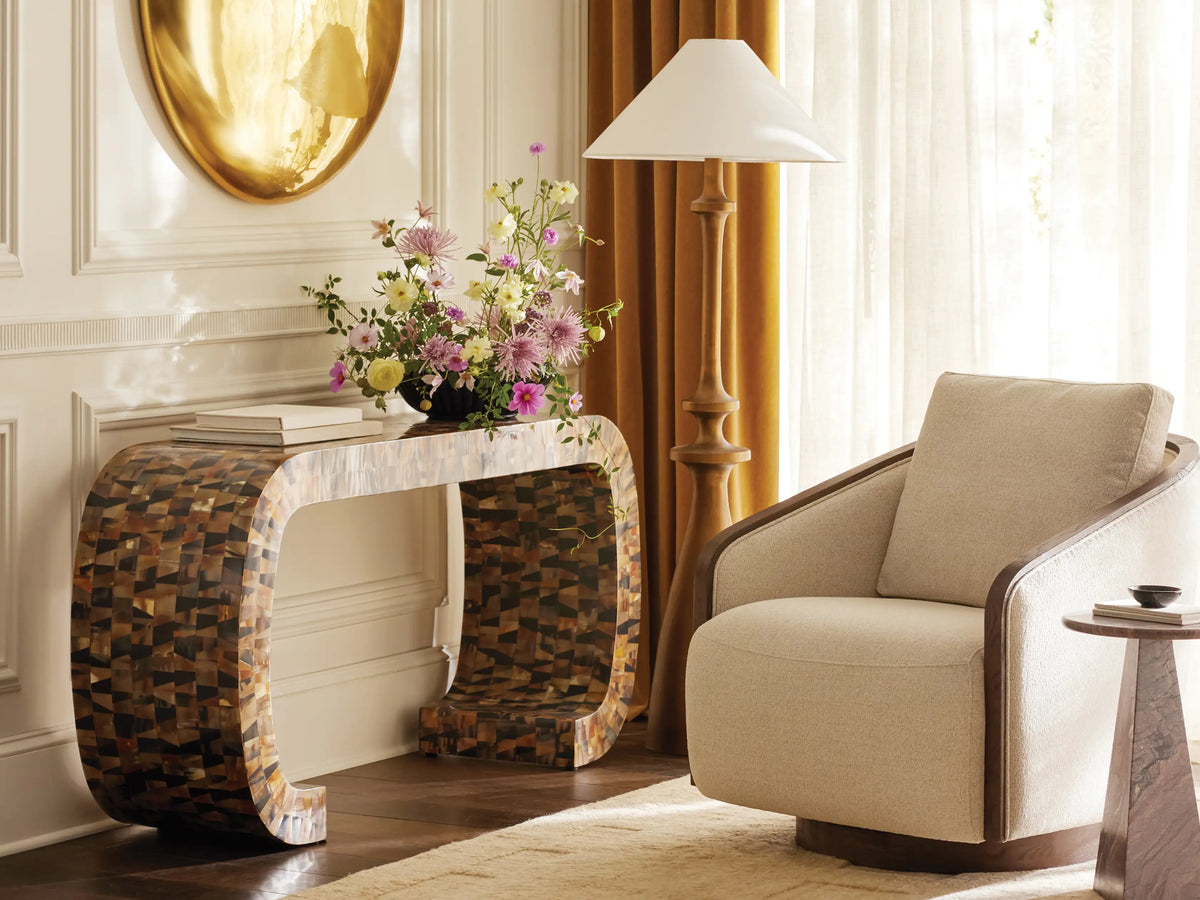 Murphy Floor Lamp with a brass-finished cast aluminum base and stem, topped with a white conical linen shade, standing on wood floor.