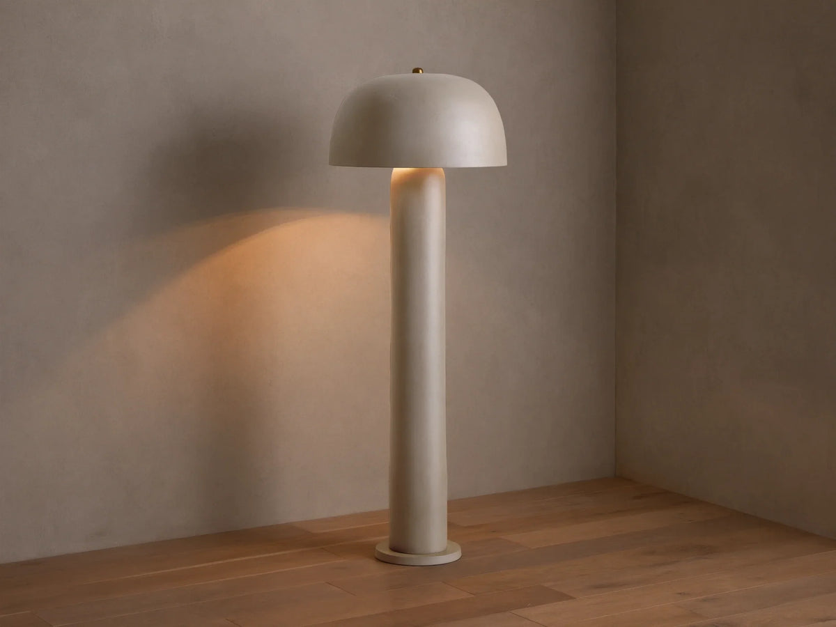 Front view of the beige Mushroom Floor Lamp with cylindrical body and dome shade, emitting warm light.