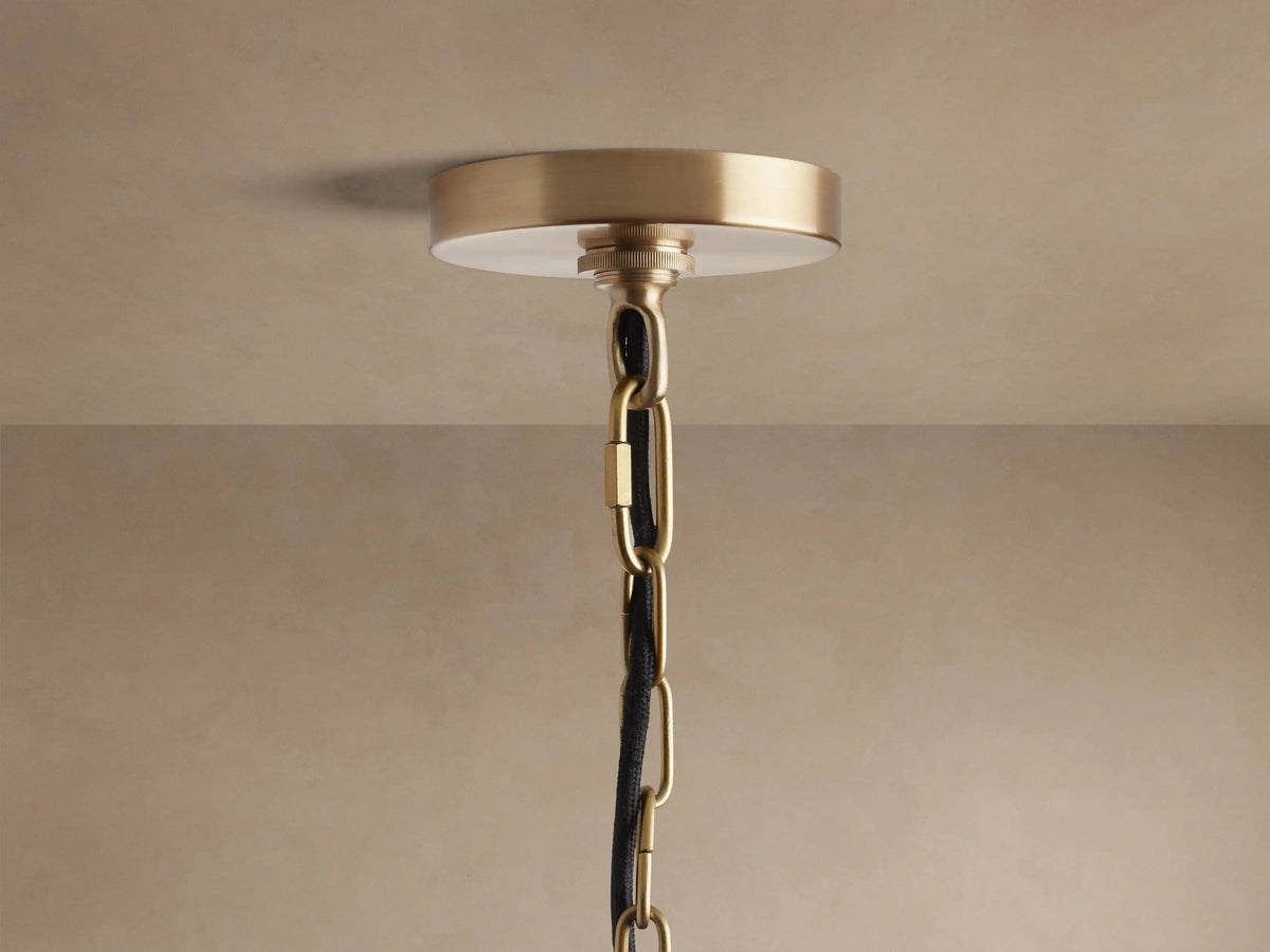 Watley Dome Pendant: Close-up showing its antique brass exterior and polished, reflective gold interior.