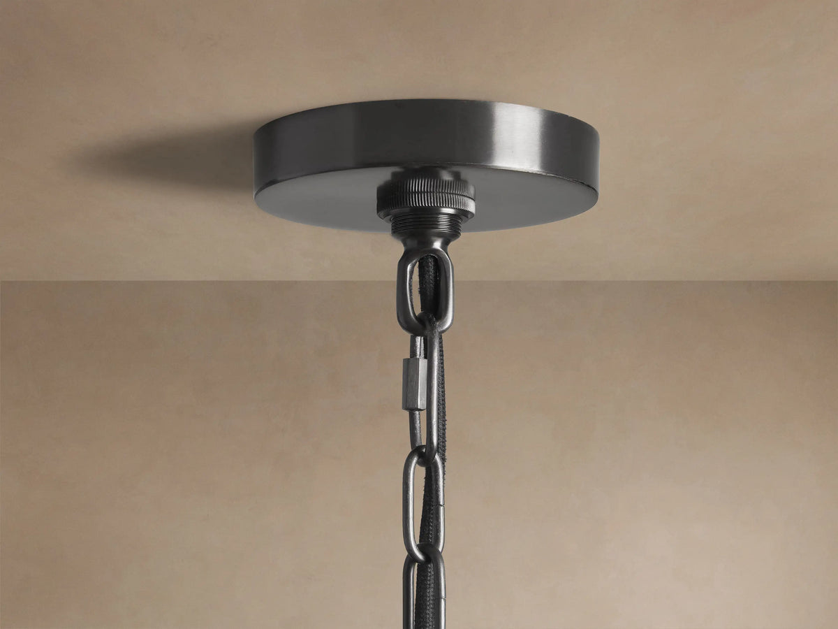 Watley Dome Pendant, close-up of curved dark exterior with brushed finish and polished antique brass interior.